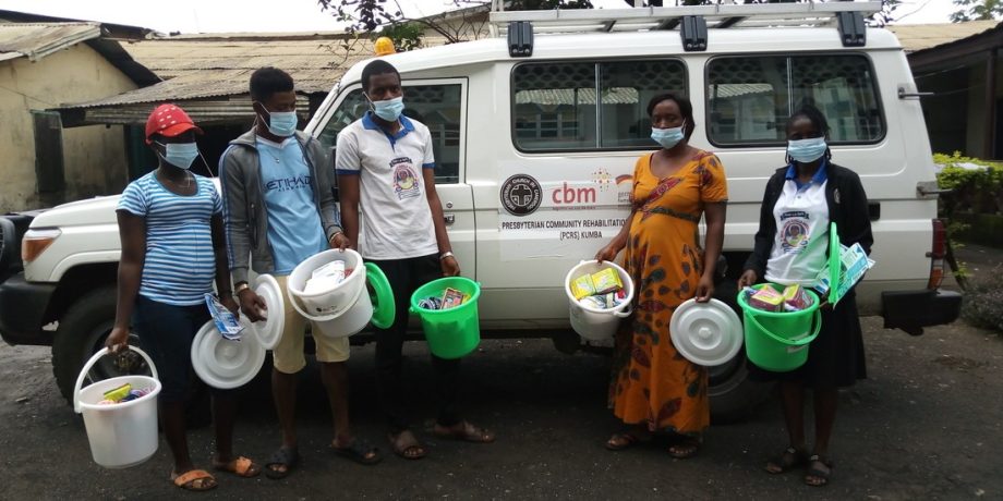 Beneficiaries posing for photograph after receiving items in Tiko Subdivision