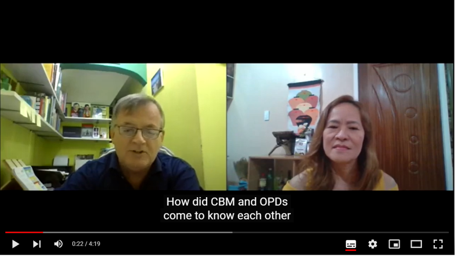 The screen image of two people is shown next to each other. The subtitles say "How did CBM and OPDs come to know each other?". This video opens on YouTube.