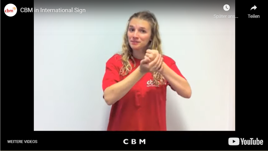 A woman is doing a sign language sign